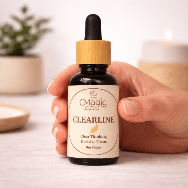 ClearLine, miscela di oli essenziali per chiarezza e concentrazione, mano con contagocce, luce calda editoriale, The Magic Apothecary