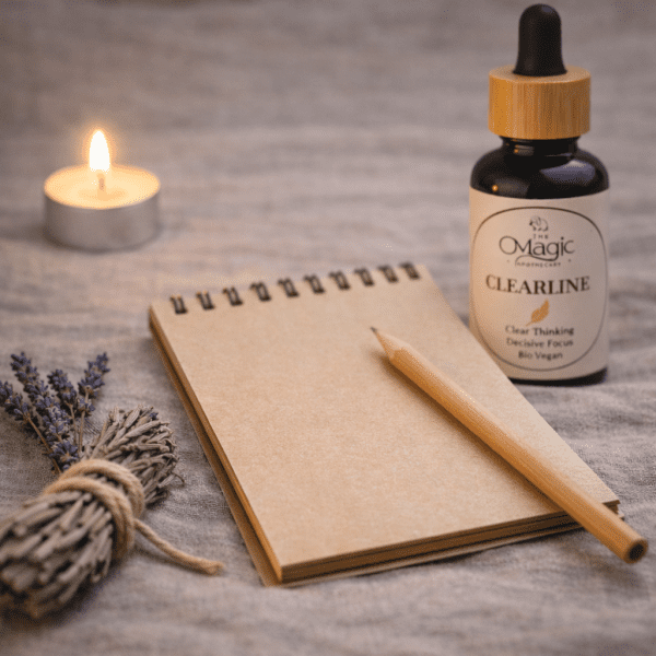 ClearLine, essential oil blend for clarity and focus, bottle beside a pen and notebook, ritual styling, label visible, The Magic Apothecary