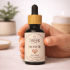Devote, essential oil blend for love and connection, hand holding the dropper, warm editorial light Devote, essential oil blend for love and connection, hand holding the dropper, warm editorial light, The Magic Apothecary