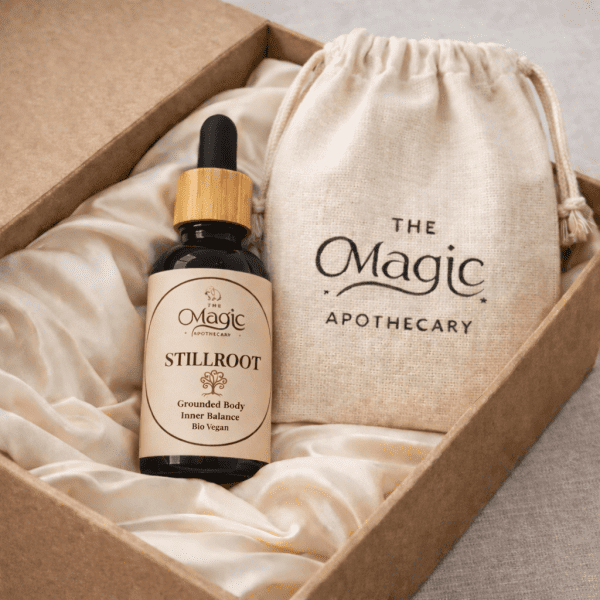 Stillroot, essential oil blend for grounding and stability, bottle detail, label visible, editorial styling, The Magic Apothecary