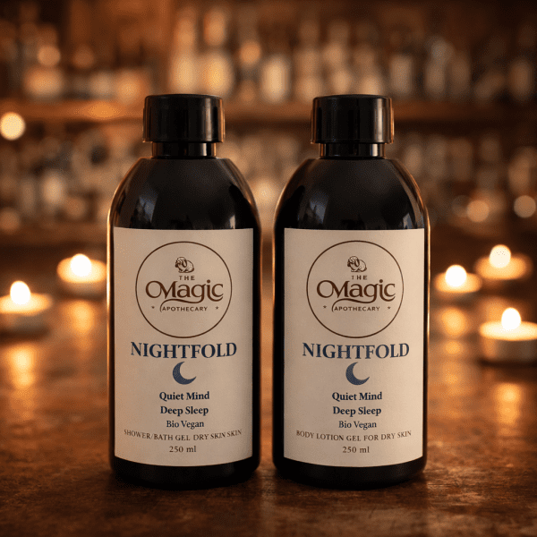 Nightfold shower gel and body cream set, dry skin, 250 ml Nightfold shower gel and body cream bottles on a table with warm candlelight in the background